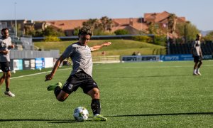 soccer player kicking ball