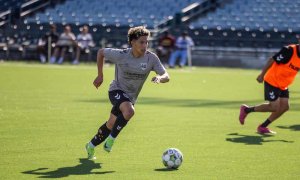 soccer player kicking ball