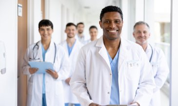 A group of residents wearing white coats