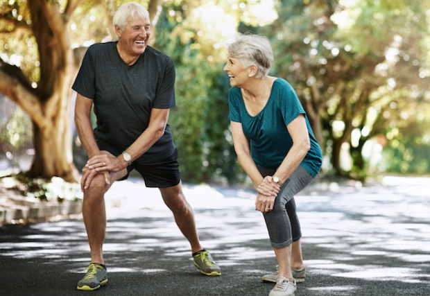 Older man and woman stretching