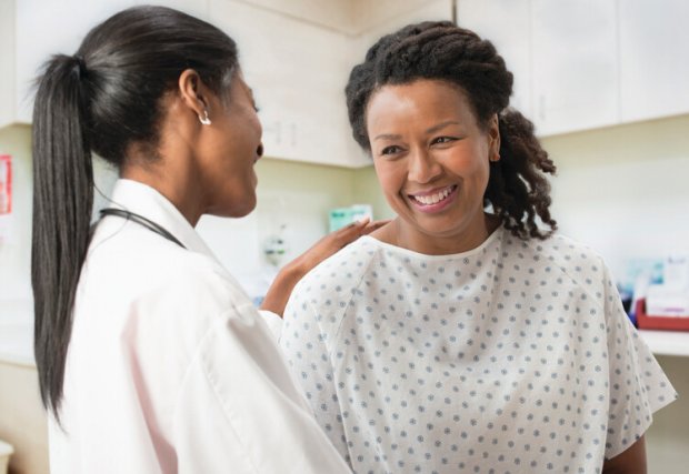 female doctor and female patient smiling