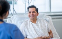 A male patient talking to a female nurse