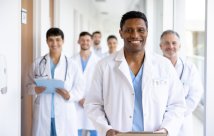 A group of residents wearing white coats