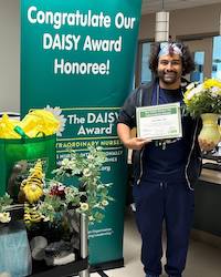 Juan Neri receiving his DAISY Award